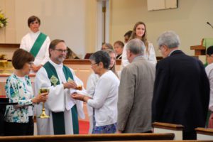 pastor giving communion