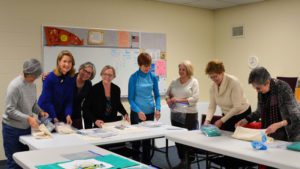 ladies in group making supply kit