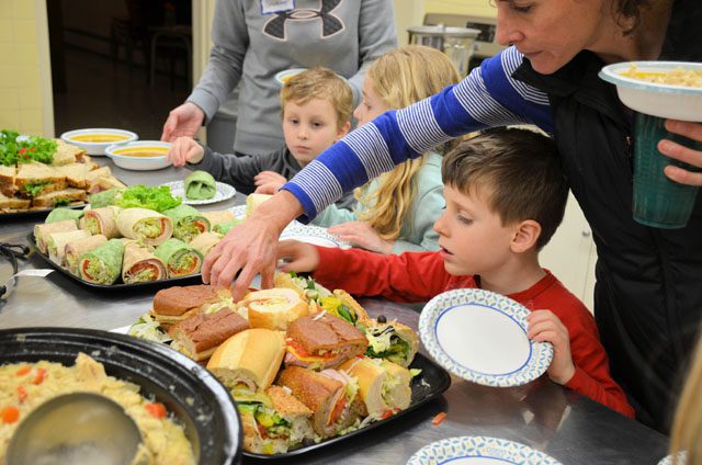 kids grabbing sandwiches